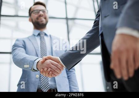 Two business men shaking hands together after successful meeting. Stock Photo