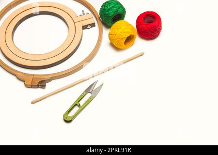 Colored yarn spools and a embroidery hook on a white background with coppy space Stock Photo