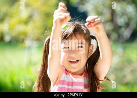 Girl laughing with egg chocolate Stock Photo