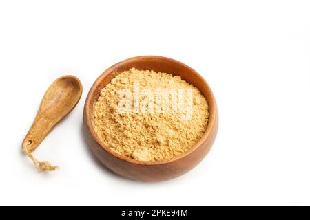 Ginger powder in a wooden bowl and a wooden spoon on a white background with copy space Stock Photo