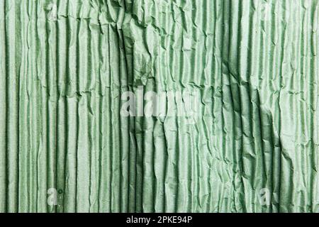 A green corrugated paper texture in a close up view Stock Photo
