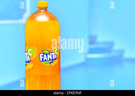 Kyiv, Ukraine, June 22,2022. Bottle of delicious orange soda Fanta on a blue Stock Photo