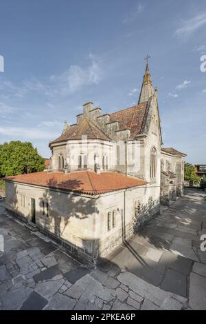 A facade of a church made of stone, with large paving slabs and clay roofs in La Ramallosa, Pontevedra, Spain on a beautiful summer day with clear ski Stock Photo