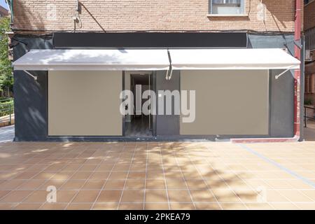 Facade of a commercial premises with awnings on the basement of a building Stock Photo