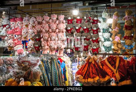 A shop in Pleiku, Vietnam, selling teddy bears, father Christmas costumes and other items of colourful clothing. Stock Photo