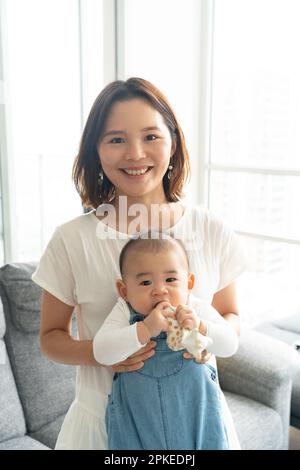 Mother holding baby boy Stock Photo