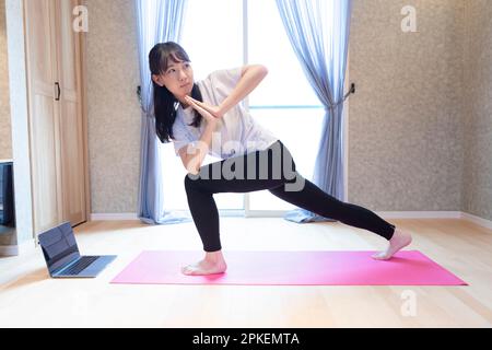 Girl doing yoga at home Stock Photo