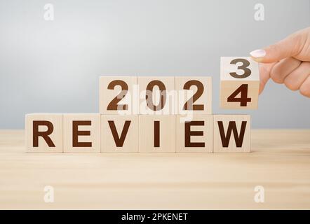 Concept Of Review 2024 Hand Flips Wooden Cube And Changes Words Review 2023 To Review 2024 New Year 2024 Economy And Business Phrase 2024 Review 2pkenet 