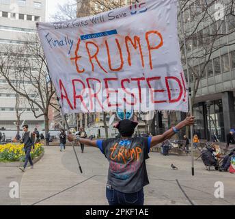NEW YORK, N.Y. – April 4, 2023: A demonstrator is seen in Lower Manhattan before an arraignment hearing for former President Donald Trump. Stock Photo