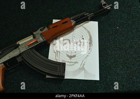 Lviv, Ukraine. April 7, 2023, Lviv, Lviv region, Ukraine: A dummy AK-47 on a table with a target representing Vladimir Putin's face shot in the right eye. An improvised shooting range managed by Andriy, a young Ukrainian, in a street near Rynok Square, in Lviv, western Ukraine, in which people can come and shoot with airsoft weapons on targets made of a picture of Russian President Vladimir Putin's face. (Credit Image: © Adrien Fillon/ZUMA Press Wire) EDITORIAL USAGE ONLY! Not for Commercial USAGE! Credit: ZUMA Press, Inc./Alamy Live News Stock Photo