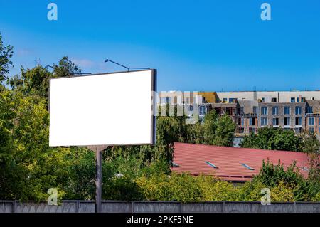 Billboard on the background of a house under construction. Billboard in the city. External advertising. Construction company. Property For Sale. Templ Stock Photo