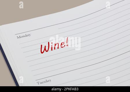 Wine reminder note in red ink in a diary page Stock Photo