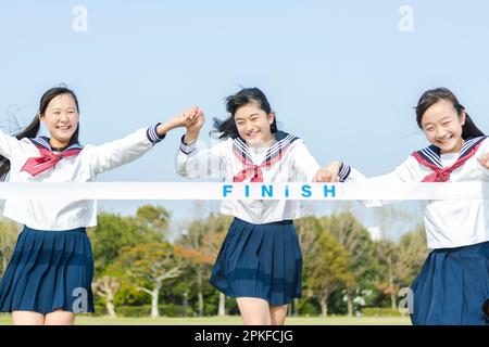 Junior high school girl at the finish line Stock Photo