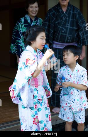 Sister and brother drinking soda pop Stock Photo