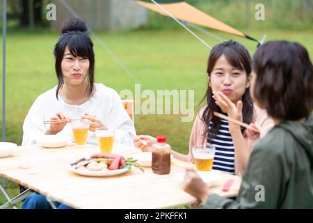 Women eating at a campsite Stock Photo