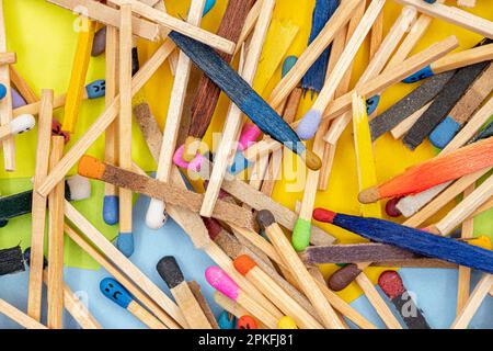 matchsticks of various shapes and colors with multicolored paper sticky notes on background Stock Photo