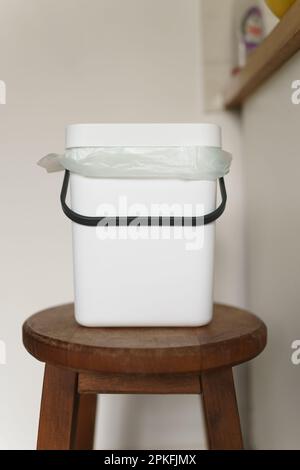 Compact bokashi container in a kitchen. Compost bin for recycling organic food waste at home. Sustainable lifestyle concept Stock Photo