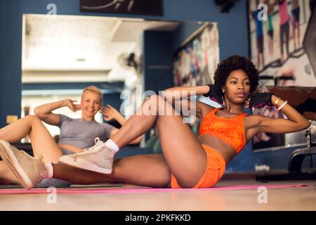 Fitness woman doing abs crunch workout in a gym. Health and lifestyle concept Stock Photo