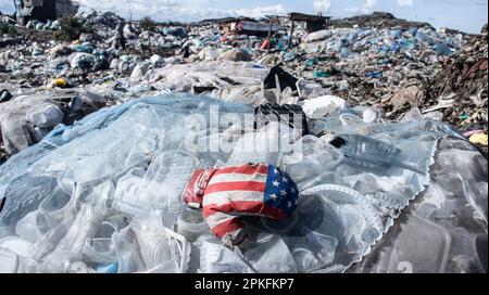 Nairobi, Kenya. 05th Apr, 2023. A boxing glove with the colors of United States of American flag is seen on a heap of plastic trash at Dandora dumping site. With most plastic being single-use and very problematic to recycle, countries especially in global south are struggling to manage the growing waste problem. (Photo by James Wakibia/SOPA Images/Sipa USA) Credit: Sipa USA/Alamy Live News Stock Photo