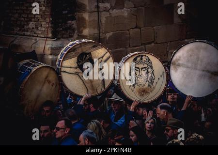 Calanda, Spain. 07th Apr, 2023. Drums depicting the face of Jesus Christ enter the place for the 'Tamborrada' on Good Friday in the municipality of Calanda. Credit: Matthias Oesterle/Alamy Live News Stock Photo