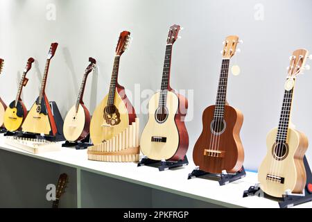 Guitars and stringed musical instruments in a store Stock Photo