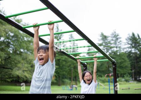Elementary school children doing cartwheels Stock Photo