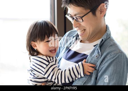 Child being carried by father Stock Photo