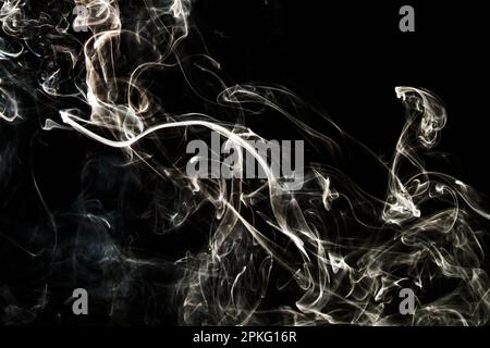Smoke effect texture. Isolated background. Black and dark backdrop. Smokey fire and mistic effect. Spirit wave. Photo realistic mist stock image. Stock Photo