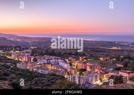 Agrigento, Sicily, Italy cityscape towards the Valley of the Temples and the Mediterranean at dawn. Stock Photo