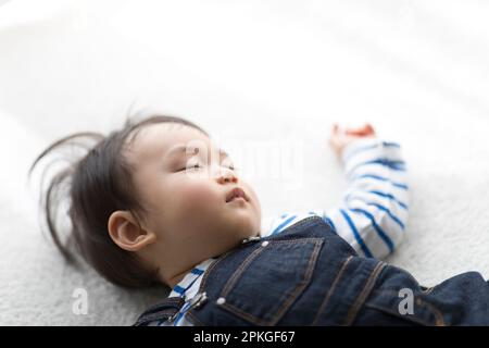 Baby sleeping in living room Stock Photo