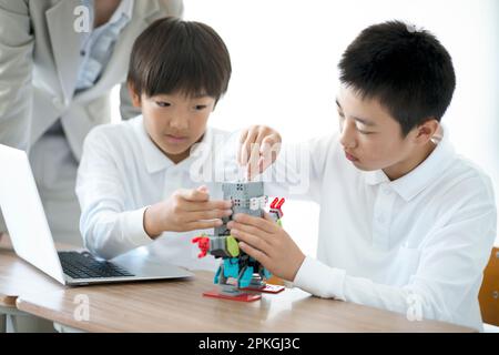 Elementary school students studying programming Stock Photo