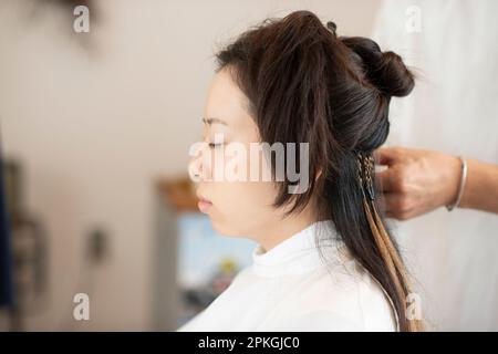 Woman getting hair extensions Stock Photo