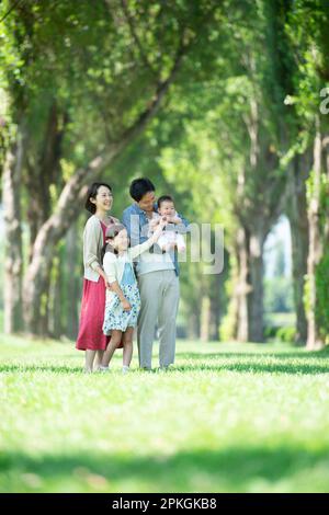Family smiling at a row of poplar trees Stock Photo - Alamy