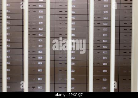 safe deposit boxes in a bank behind bars Stock Photo