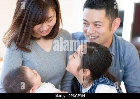Family chatting around baby Stock Photo
