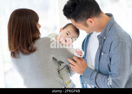 Parents watching over baby Stock Photo