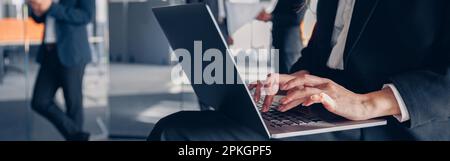 Close up of unrecognisable businesswoman working on laptop in office Stock Photo