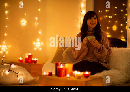 Woman drinking in candlelight Stock Photo