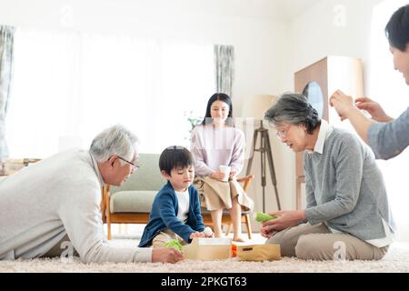 Grandparents and grandchildren playing with toys Stock Photo
