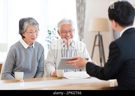 A senior couple talking with a businessman Stock Photo