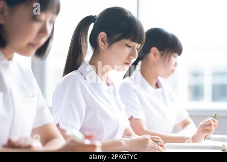 Nursing students taking a class in a classroom Stock Photo