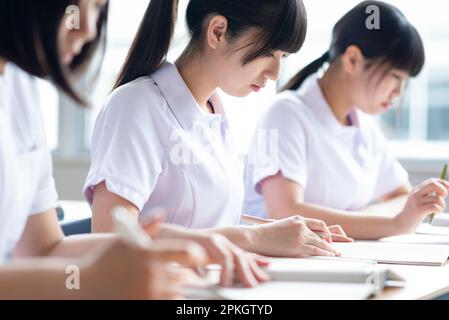 Nursing students taking a class in a classroom Stock Photo