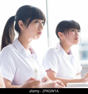 Nursing students taking a class in a classroom Stock Photo