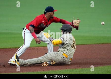 Atlanta Braves designated hitter Orlando Arcia is mobbed by