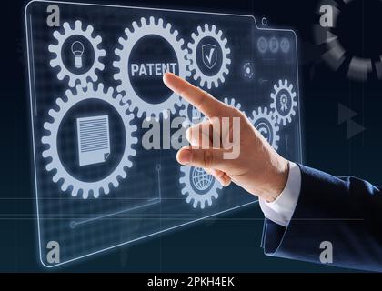 Patent concept. Man pressing button on virtual screen, closeup Stock Photo