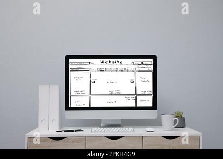 Computer with sketch of website planning and design on white table Stock Photo