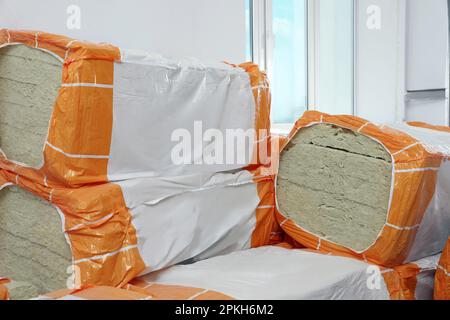 Packages of thermal insulation material in room Stock Photo