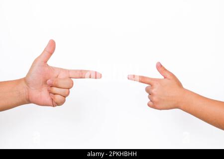 Pointing finger of mother and her child on white background. Fingers of two people nearly touching. Stock Photo