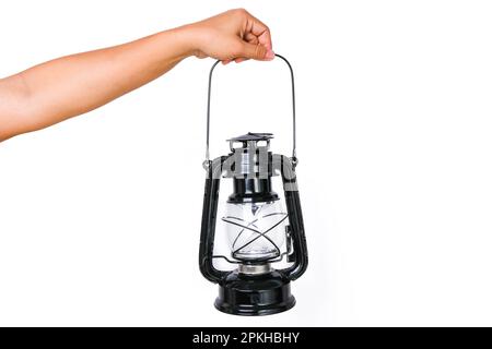 Hand holding black lantern isolated on white background. Lamp in hand Stock Photo