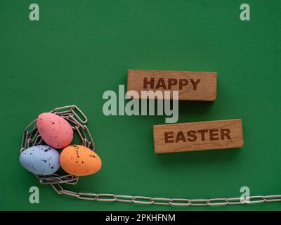 Easter eggs on green background with metal chain Stock Photo